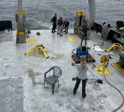 A team of scientists preparing to deploy an oceanographic instrument